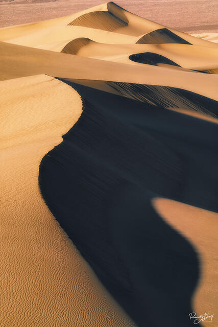 sunset over the mesquite flat sand dunes in Death Valley national park.