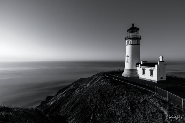 black and white fine art print of the North Head Lighthouse at Cape Disappointment in Washington during sunset.