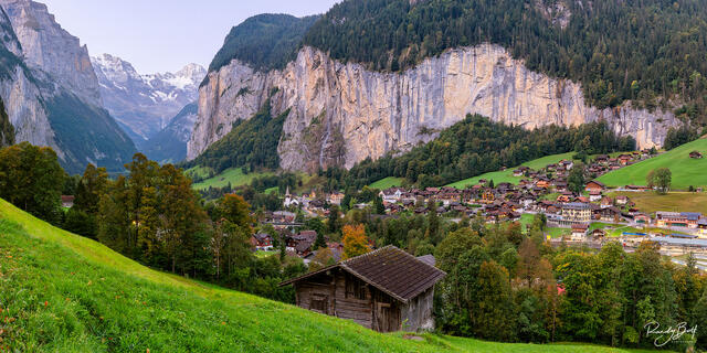 a panoramic photograph of sunrise in Lauterbrunnen Switzerland in the Swiss alps.