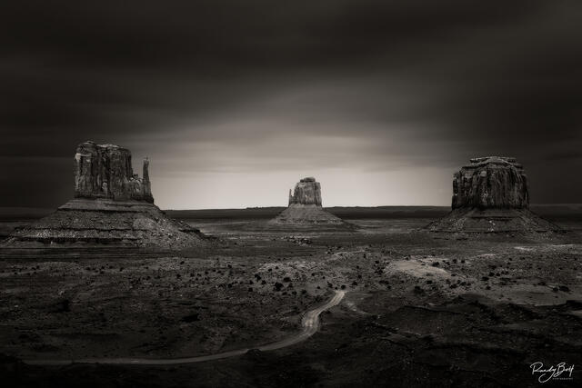 black and white long exposure image of Monument Valley