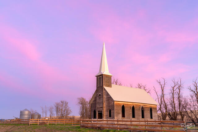 Locust grove church in Oregon with pastel pink clouds at sunset