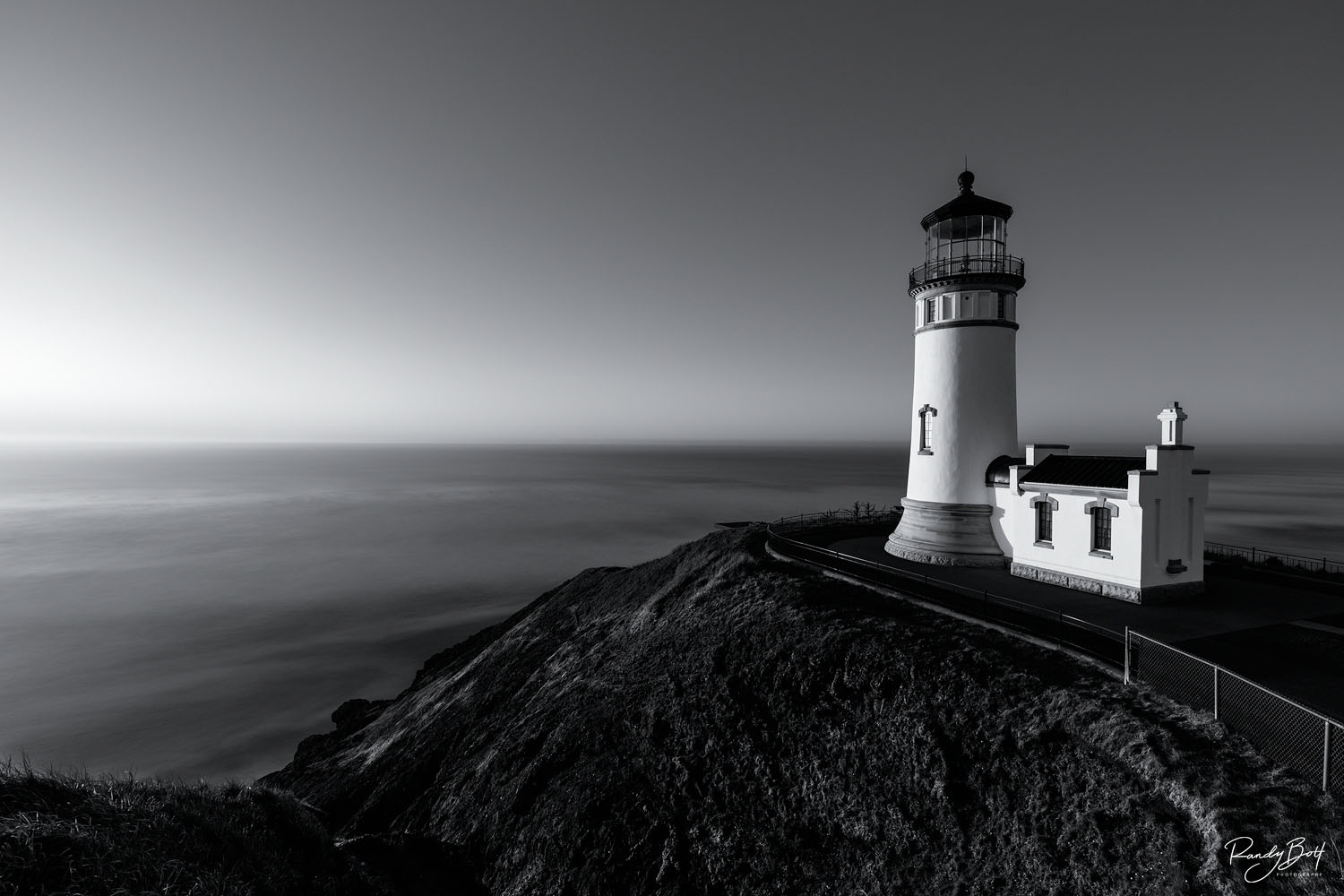 Eternity black and white fine art print of the North Head Lighthouse at Cape Disappointment in Washington during sunset.