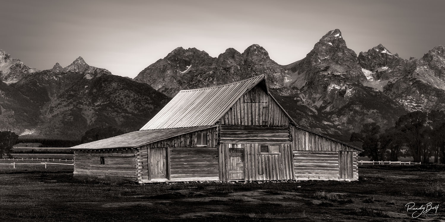 Mormon Row Barn Moulton Barn with the Grand Tetons in black and white.