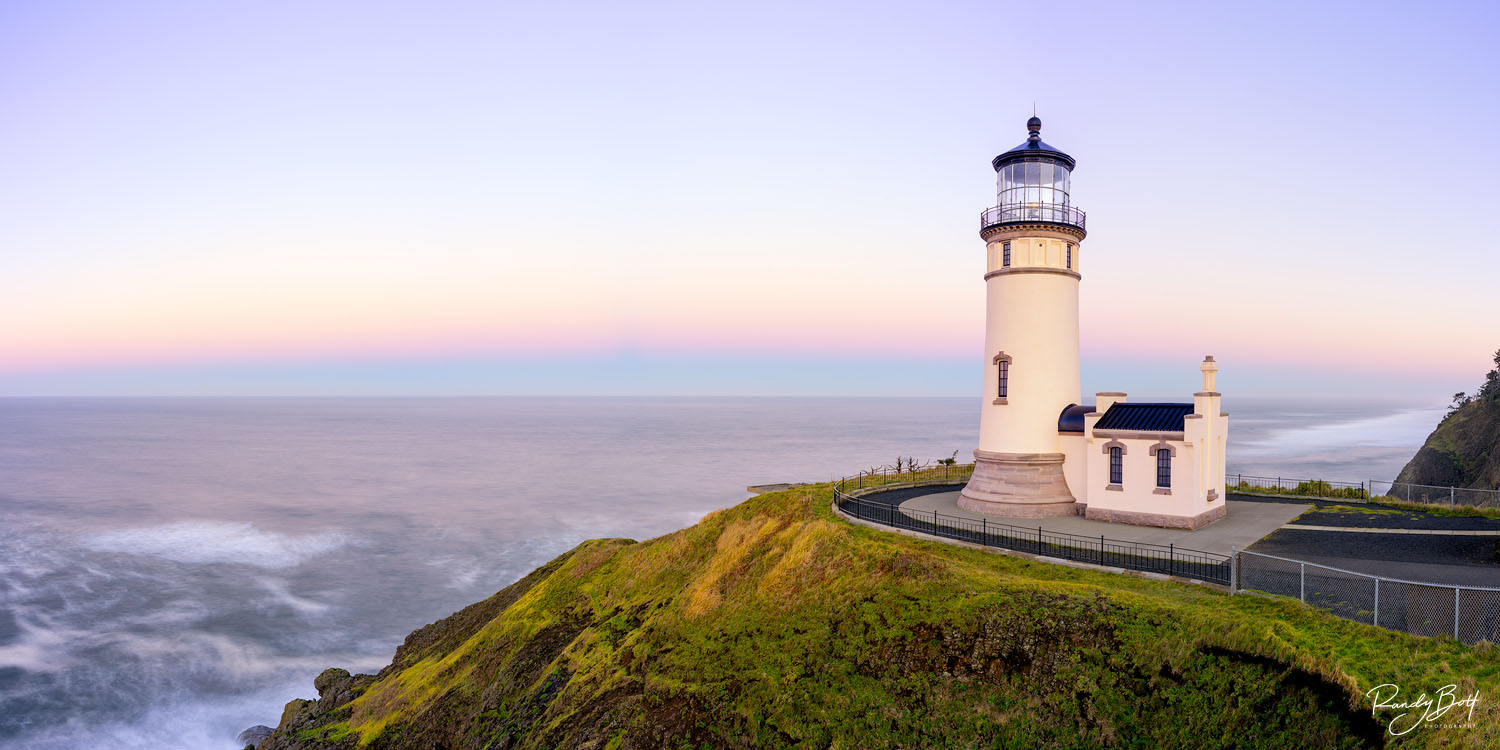 North Head Sunrise sunrise at the North Head Lighthouse at Cape Disappointment in Washington State with alpen glow over the ocean.
